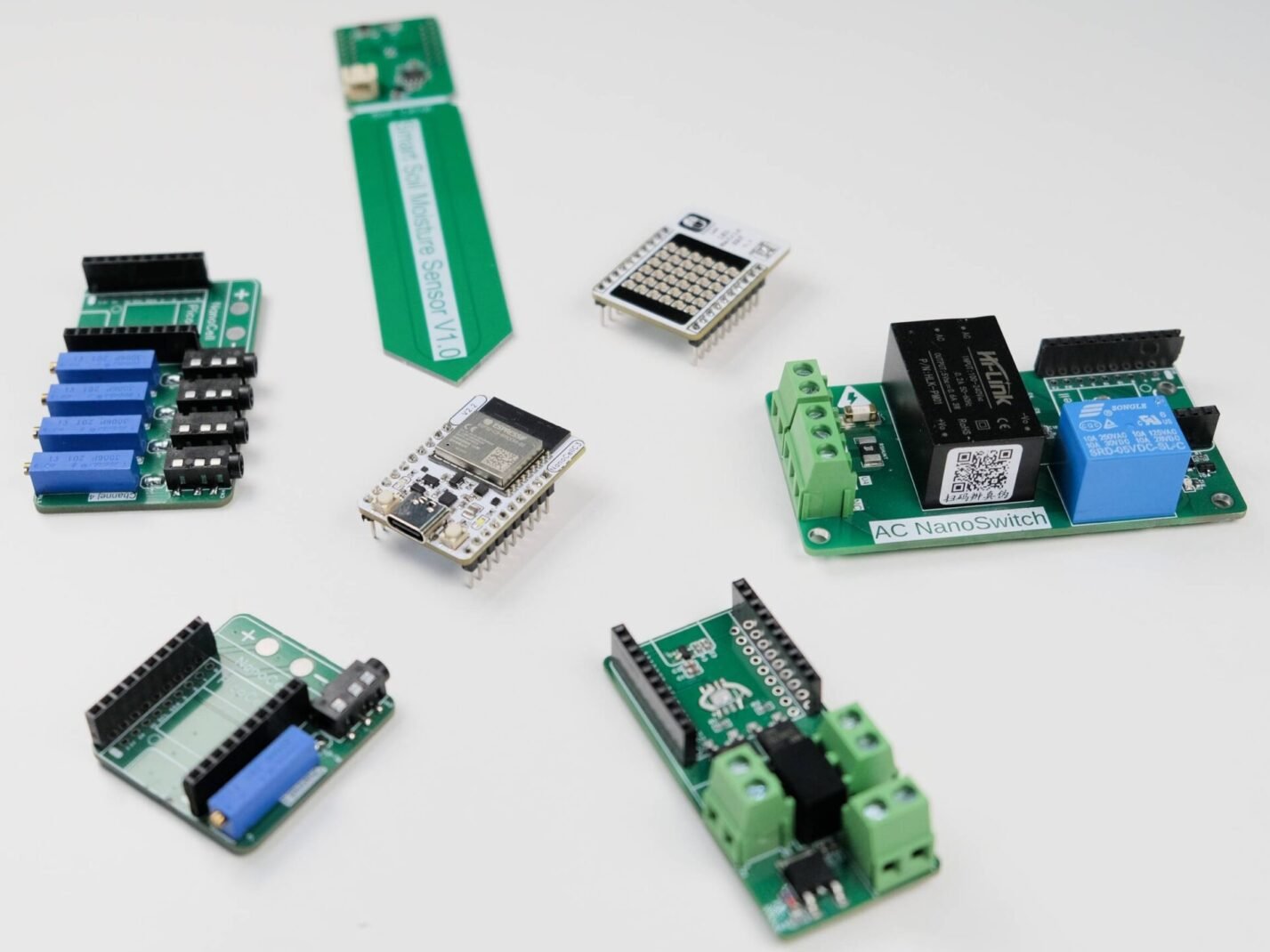 The Sprig Labs board family: an ESP32-C3 development board surrounded by stackable expansion PCBs.